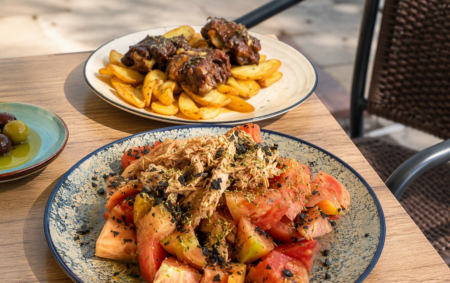 Tomato salad and rabo de toro on the terrace